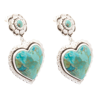 A pair of silver-toned drop earrings featuring heart-shaped turquoise stones with a smaller round turquoise accent above, set against a plain white background.
