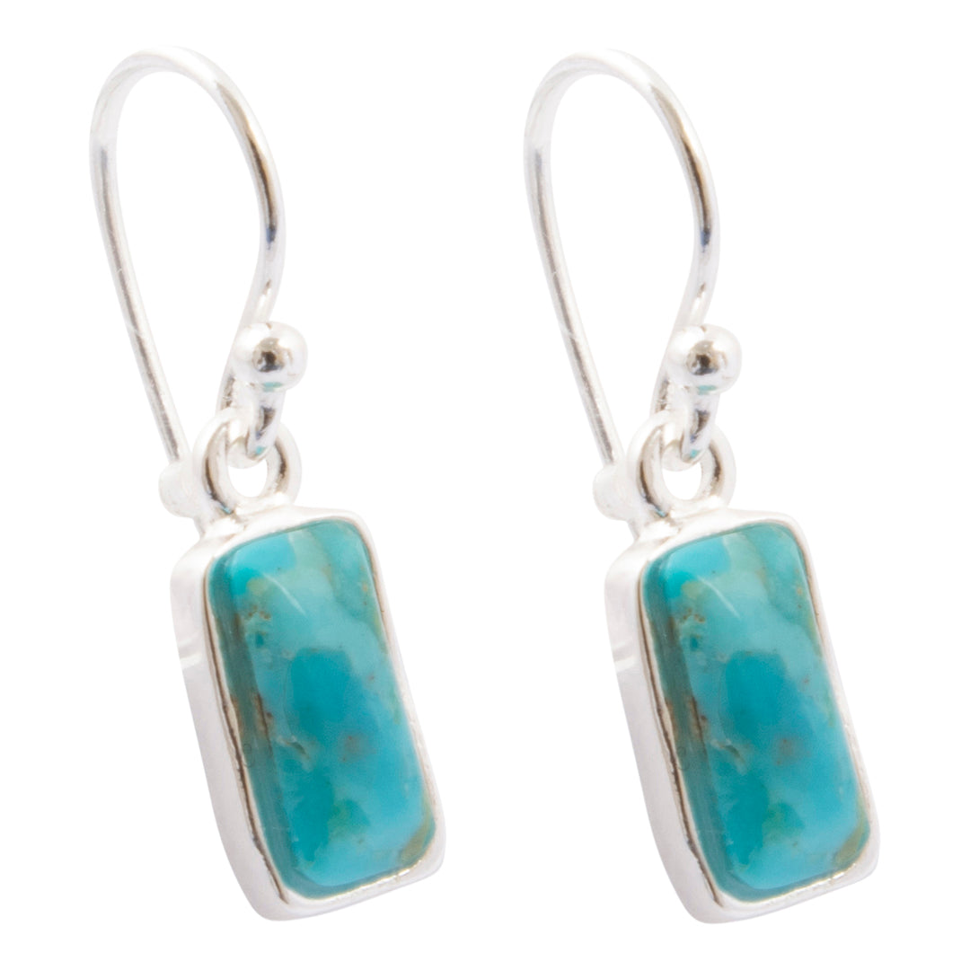 A pair of silver drop earrings featuring rectangular turquoise-blue stone pendants with natural marbling, set in polished silver bezels with fishhook wires.