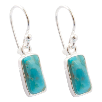 A pair of silver drop earrings featuring rectangular turquoise-blue stone pendants with natural marbling, set in polished silver bezels with fishhook wires.