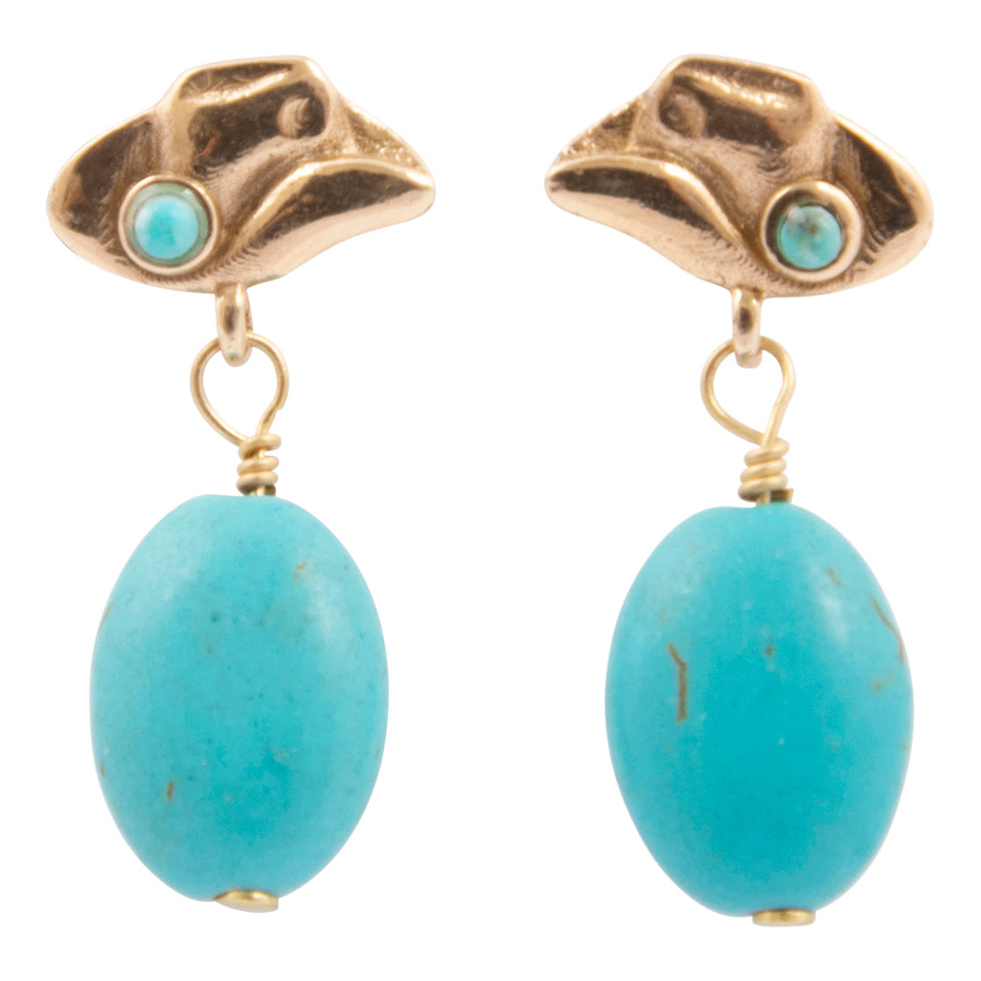 Pair of earrings with gold tops and turquoise beads on a white background