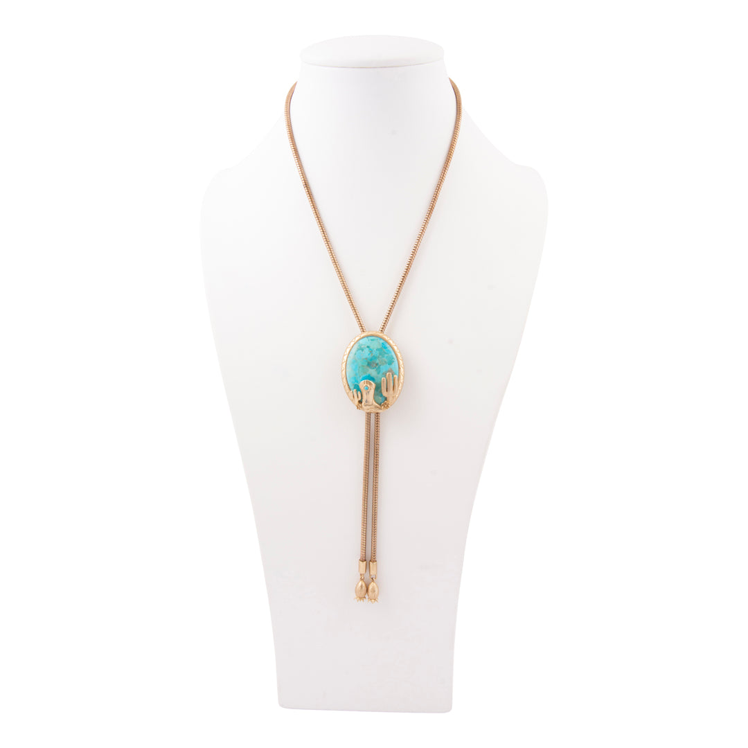 Necklace with a turquoise pendant on a mannequin bust against a white background