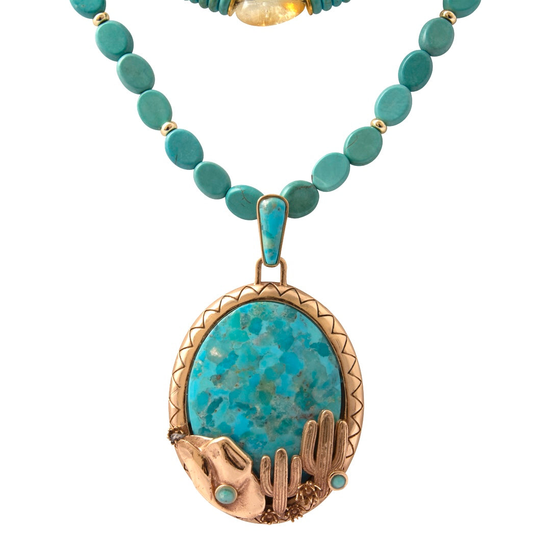 Turquoise necklace with a detailed pendant on a white background
