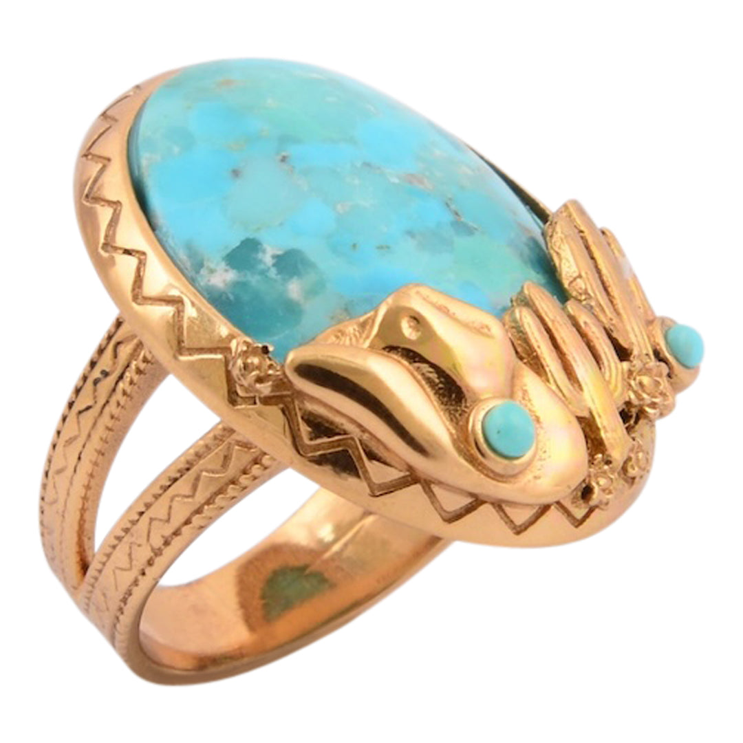 Gold ring with turquoise stone on a white background