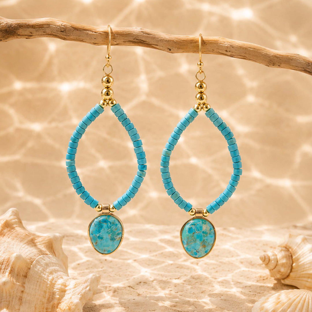 Barse Earthbound turquoise charm earrings with blue magnesite beaded frames on a styled background