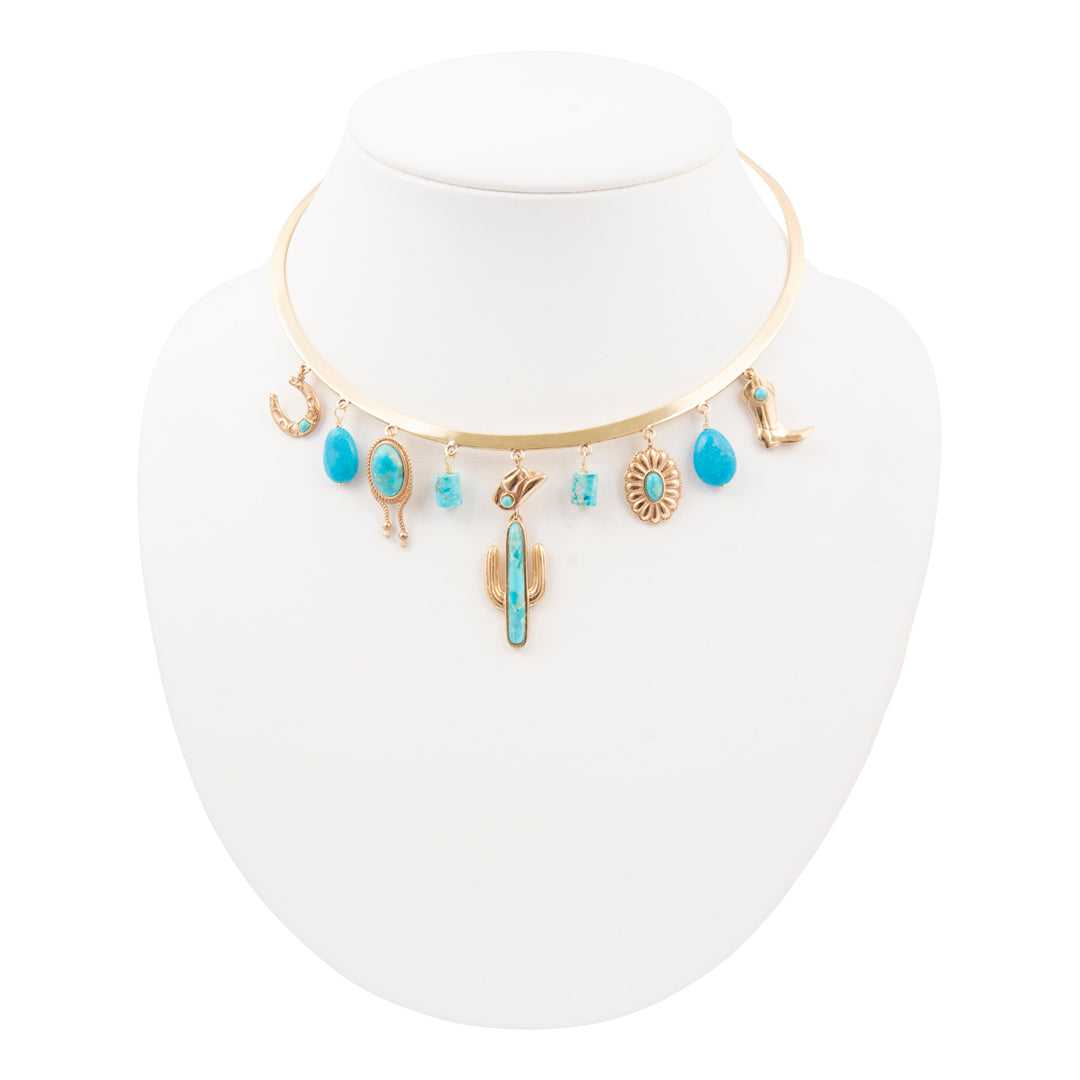 Necklace with turquoise stones and gold accents on a white mannequin bust.