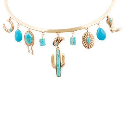 Gold and turquoise charm bracelet on a white background