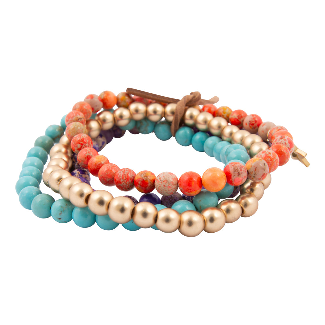 Stack of colorful beaded bracelets on a white background