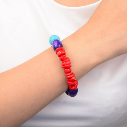 Colorful beaded bracelet on a wrist against a white background