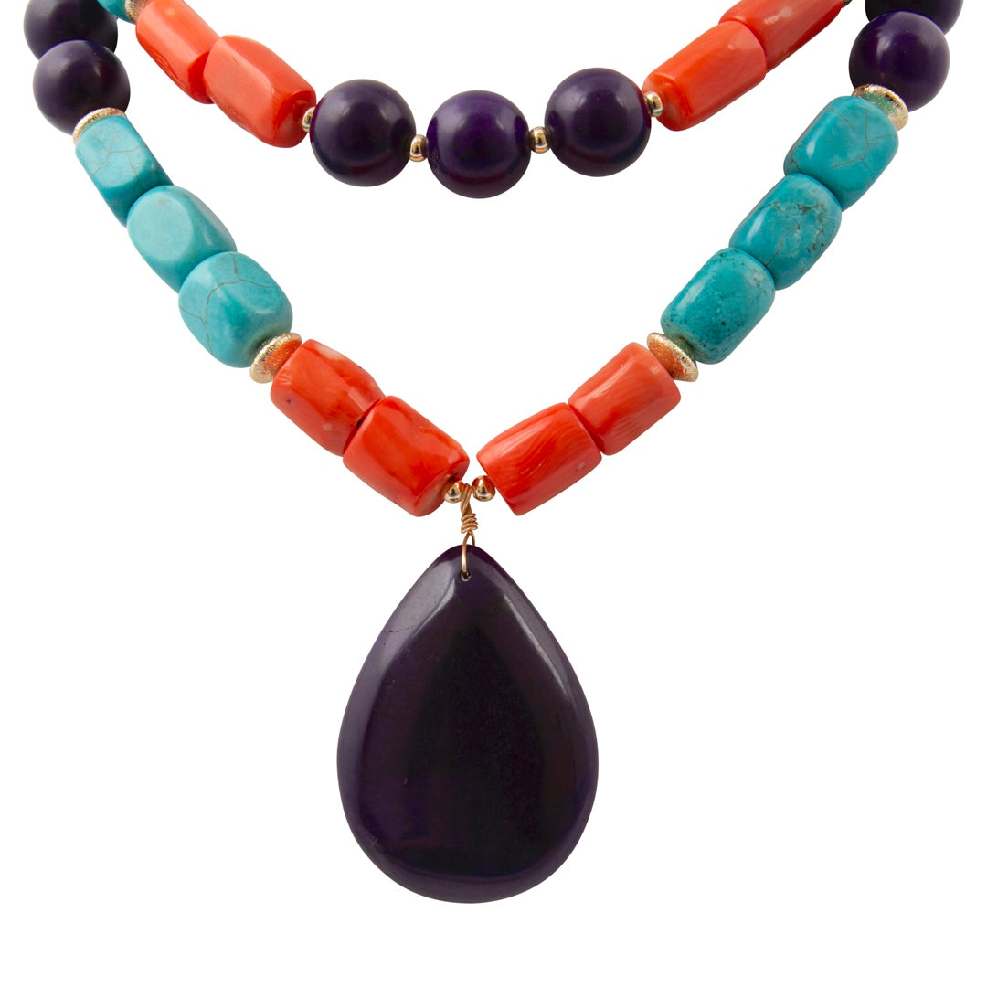 Necklace with purple teardrop pendant and colorful beads on a white background