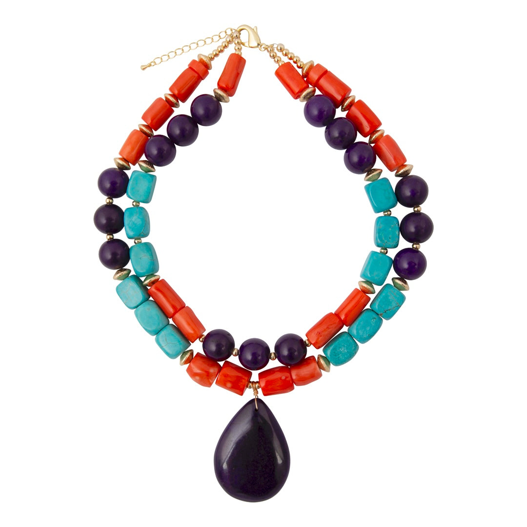 Multicolored beaded necklace with a large dark bead on a white background