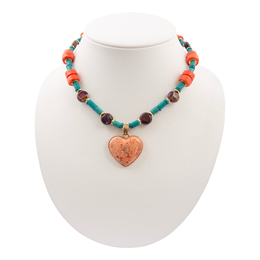 Necklace with a heart pendant on a mannequin bust against a white background