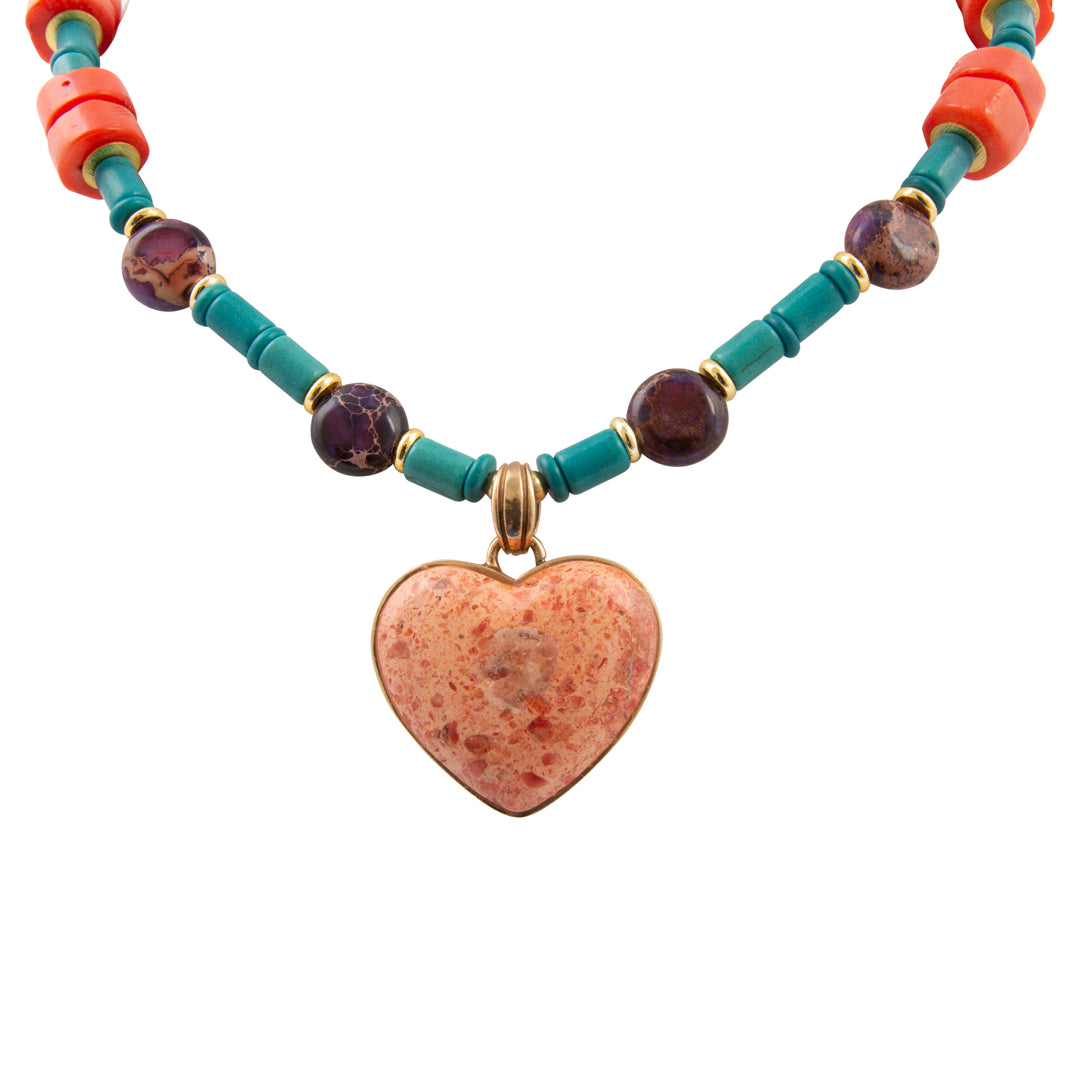 Necklace with heart pendant and colorful beads on a white background