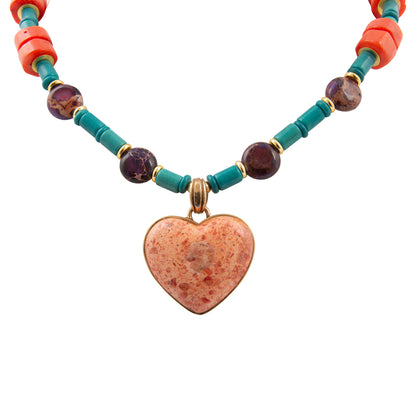 Necklace with heart pendant and colorful beads on a white background
