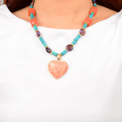 Necklace with a heart-shaped pendant and colorful beads on a white background