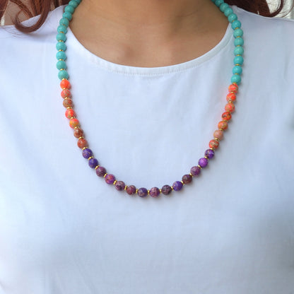 Colorful beaded necklace worn by a person on a white background