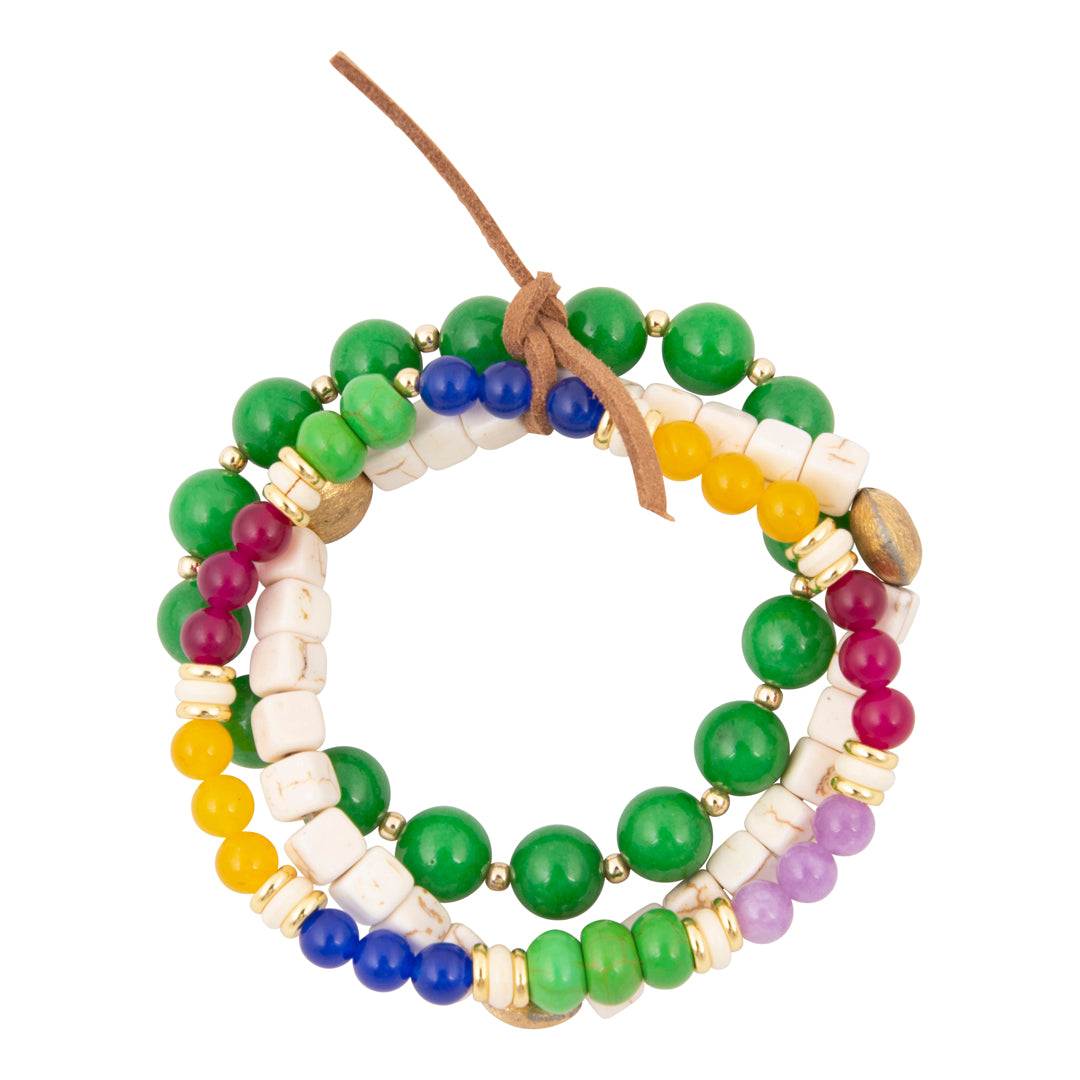 Colorful beaded bracelet with green, white, blue, yellow, and purple beads on a white background