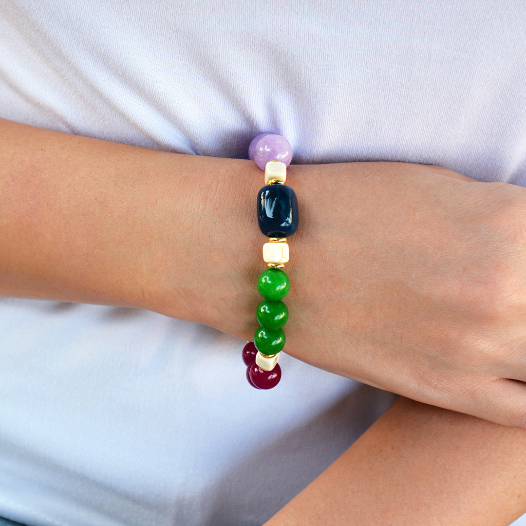 Colorful beaded bracelet on a wrist against a white background