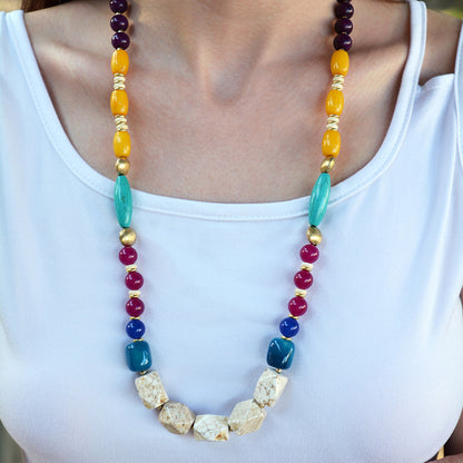 Colorful beaded necklace worn by a person on a white background