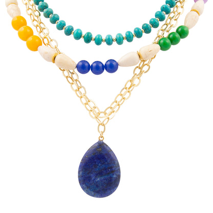 Multistrand necklace with colorful beads and a blue pendant on a white background