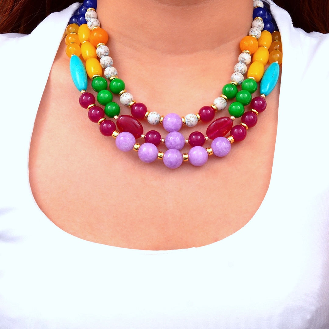 Colorful beaded necklace on a person wearing a white shirt