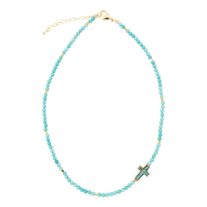 Turquoise beaded necklace with a cross pendant on a white background