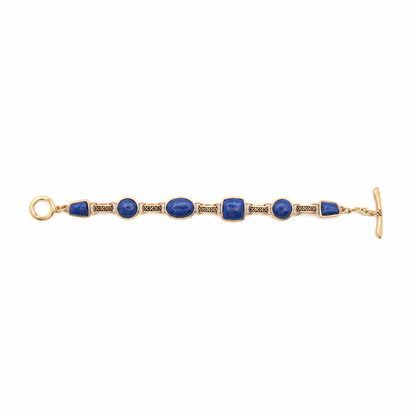 A gold-tone bracelet featuring multiple oval and rectangular blue lapis lazuli stones set in a gold bezel, with a toggle clasp closure, shown against a plain white background.