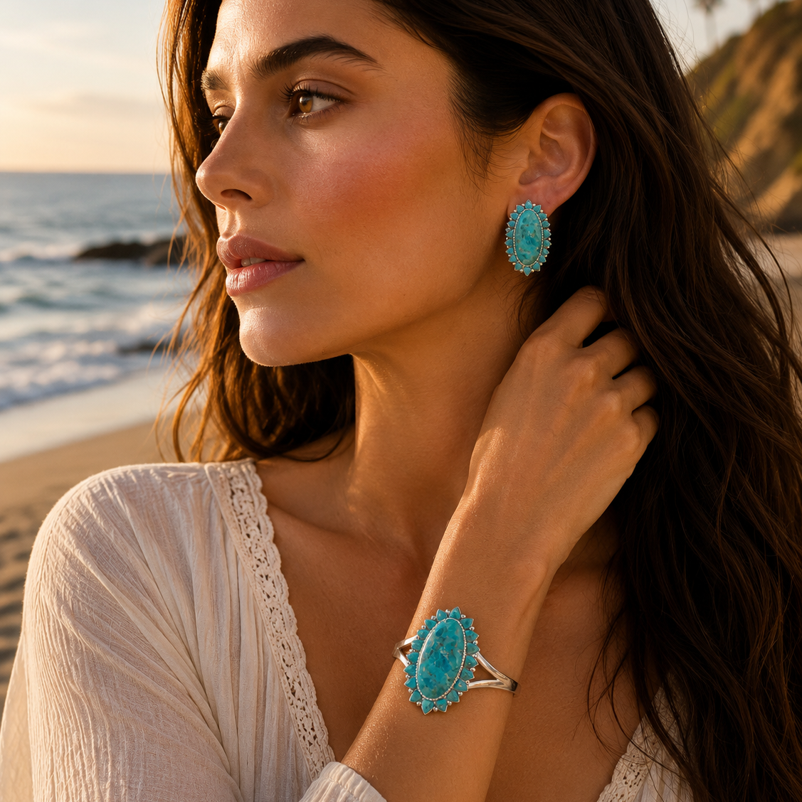 Woman wearing turquoise earrings and ring on a beach