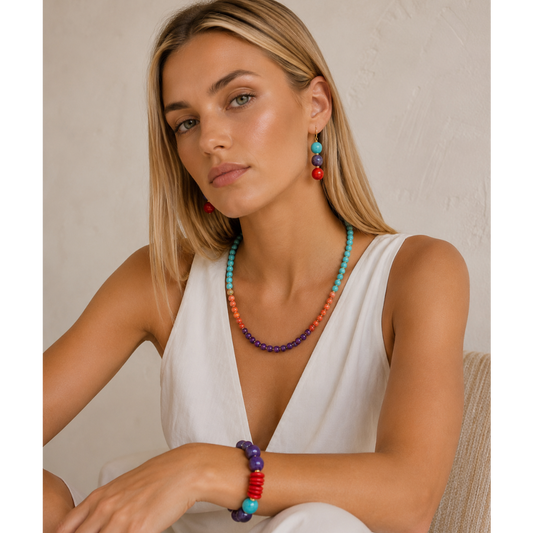 Woman wearing colorful jewelry against a neutral background