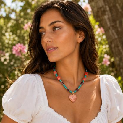 Woman wearing a colorful necklace with a heart pendant in a natural setting