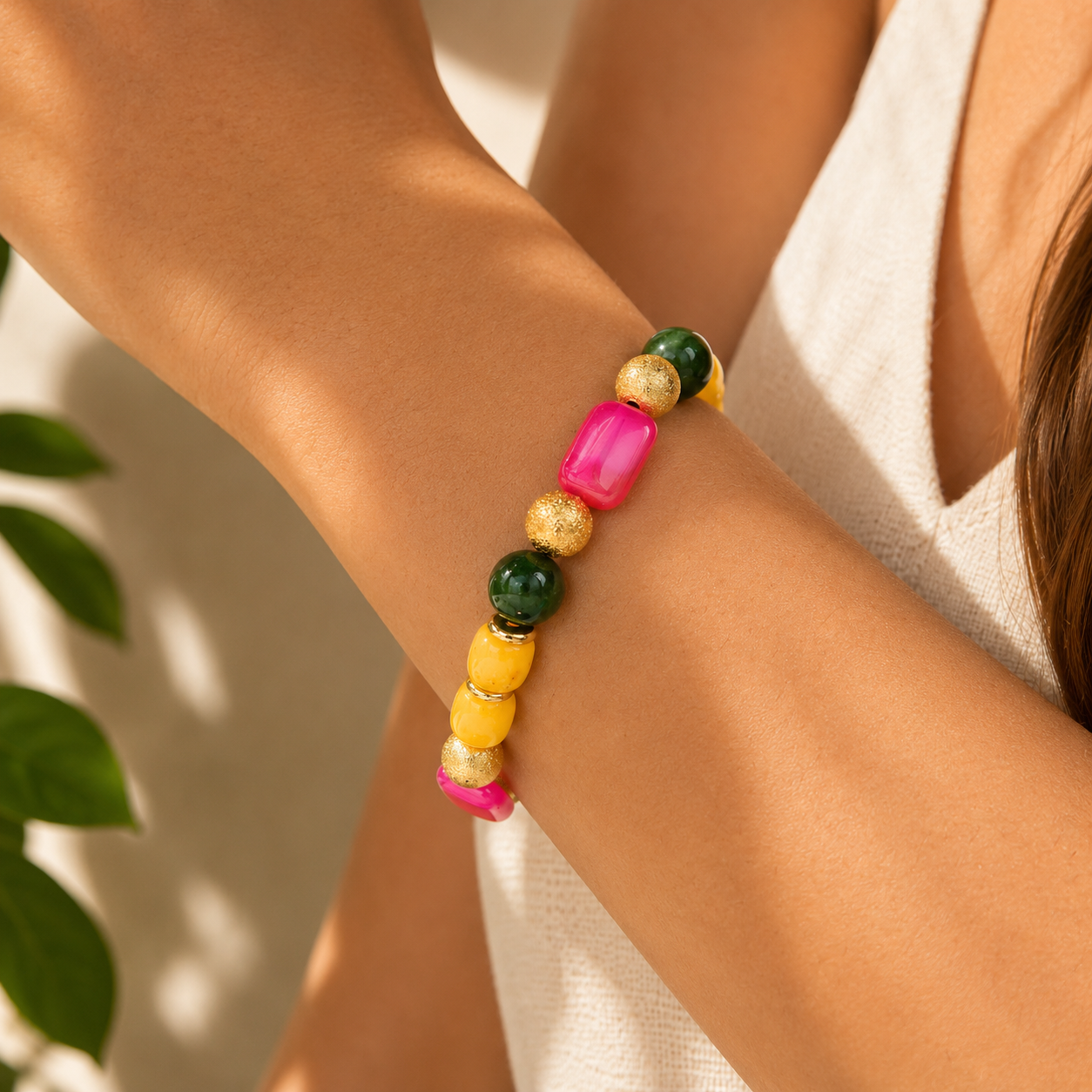 Colorful beaded bracelet on a person's wrist with a neutral background