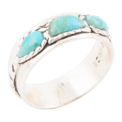 Silver ring with turquoise stones on a white background
