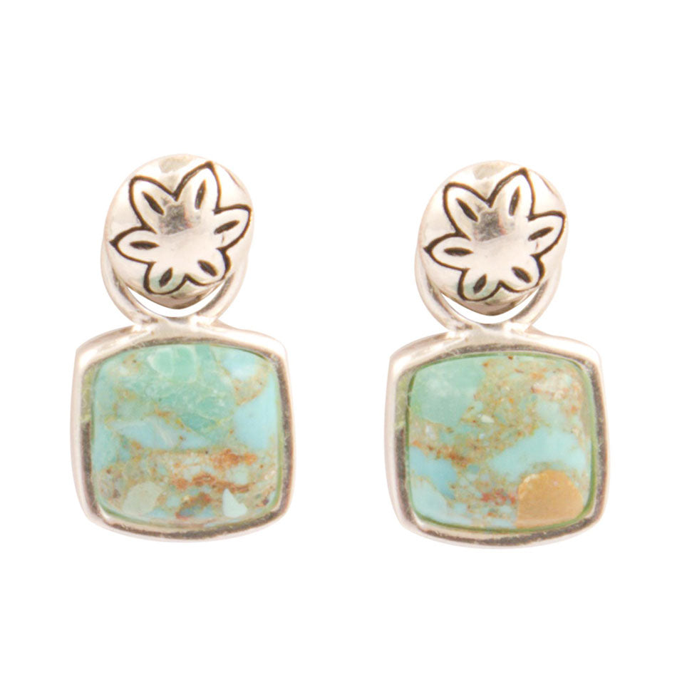Pair of earrings with floral designs and turquoise stones on a white background