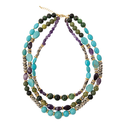 A multi-strand beaded necklace featuring turquoise, olive green, purple, and dark gray beads with gold-toned spacers and clasp, displayed on a clean white background.