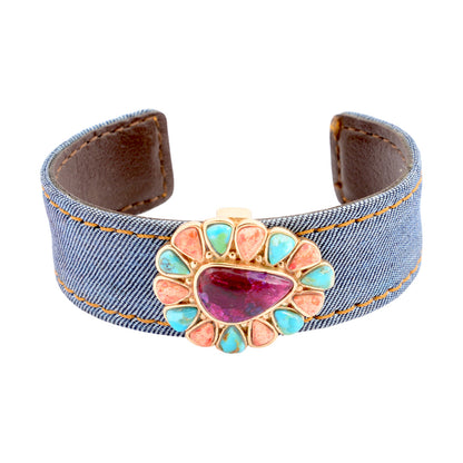 Denim bracelet with a colorful stone and brown leather accents on a white background