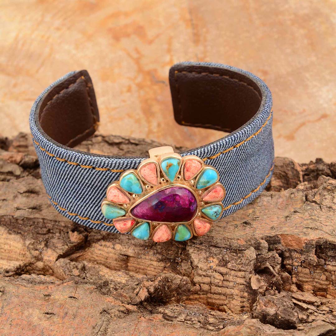 Denim bracelet with a colorful stone on a wooden surface