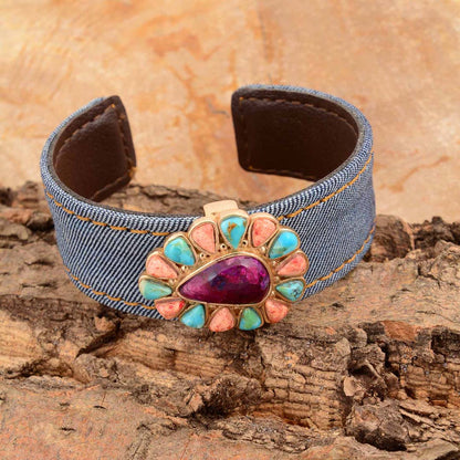 Denim bracelet with a colorful stone on a wooden surface