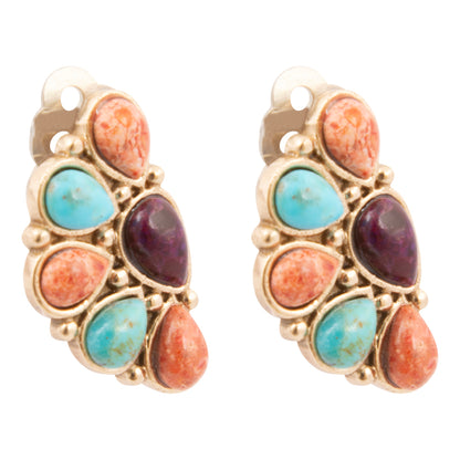 Pair of earrings with gold frame, turquoise, and red stones on a white background