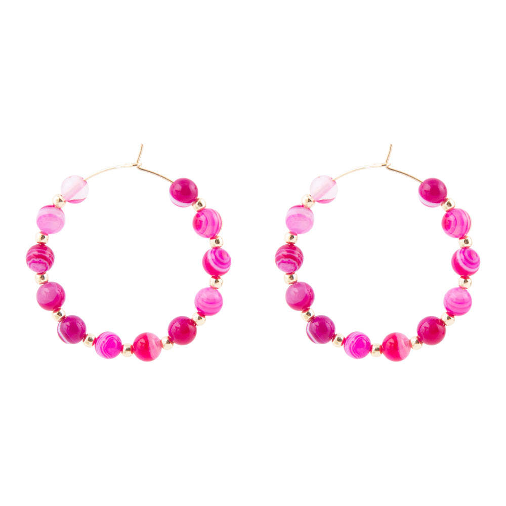 Pair of pink beaded hoop earrings on a white background