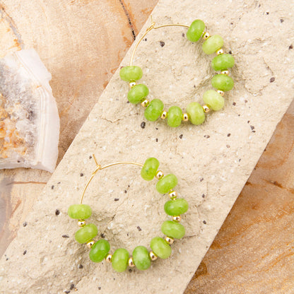 Green beaded bracelet on a textured stone surface