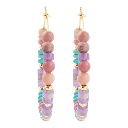 A pair of long beaded drop earrings with gold-tone hooks, featuring pink and lavender beads, light blue beads, and small gold spacer beads on a white background.