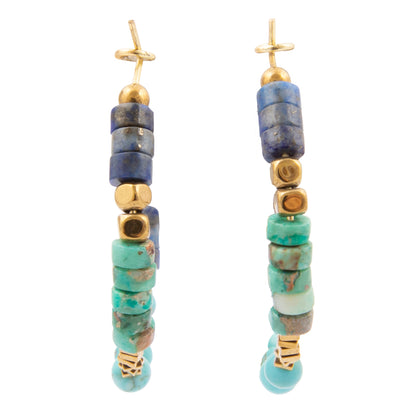 Beaded earrings with blue, green, and gold beads on a white background
