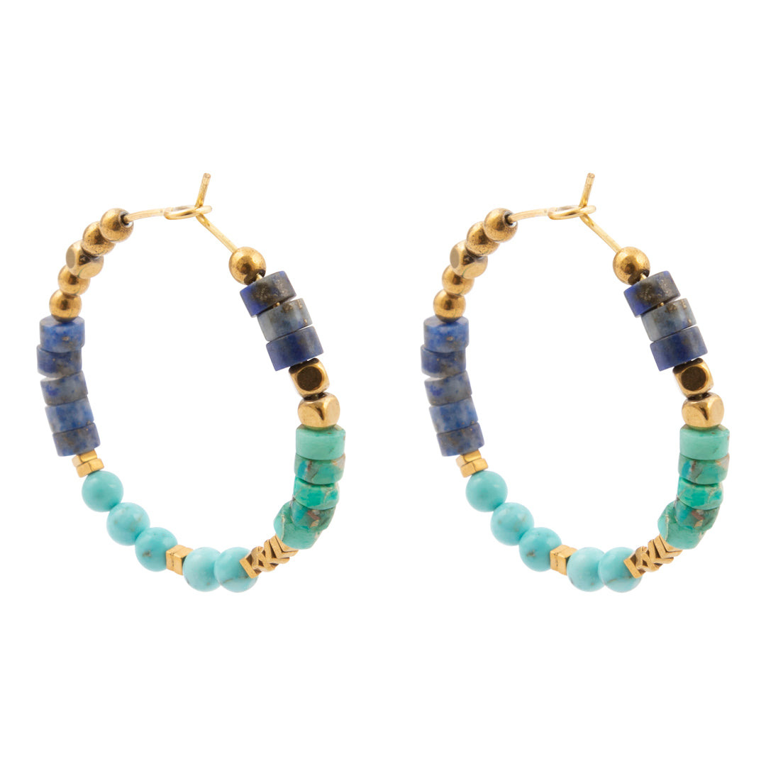 Pair of hoop earrings with blue and green beads on a white background