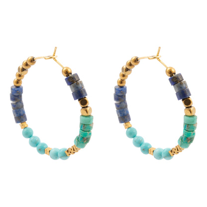 Pair of hoop earrings with blue and green beads on a white background