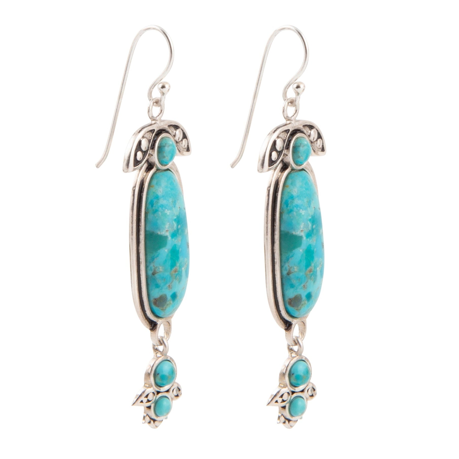 Turquoise stone earrings with silver accents on a white background