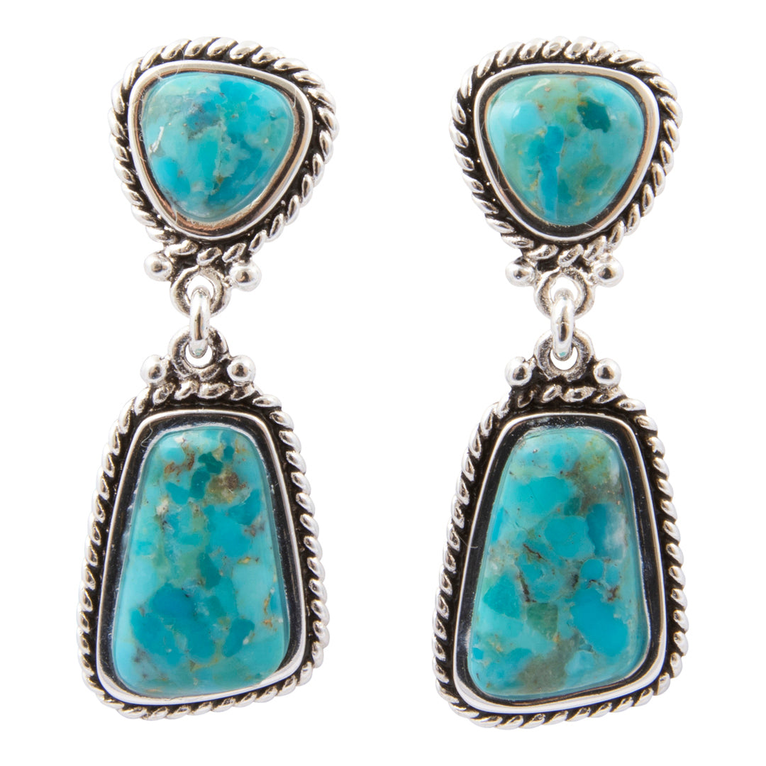 Turquoise stone earrings with silver frames on a white background