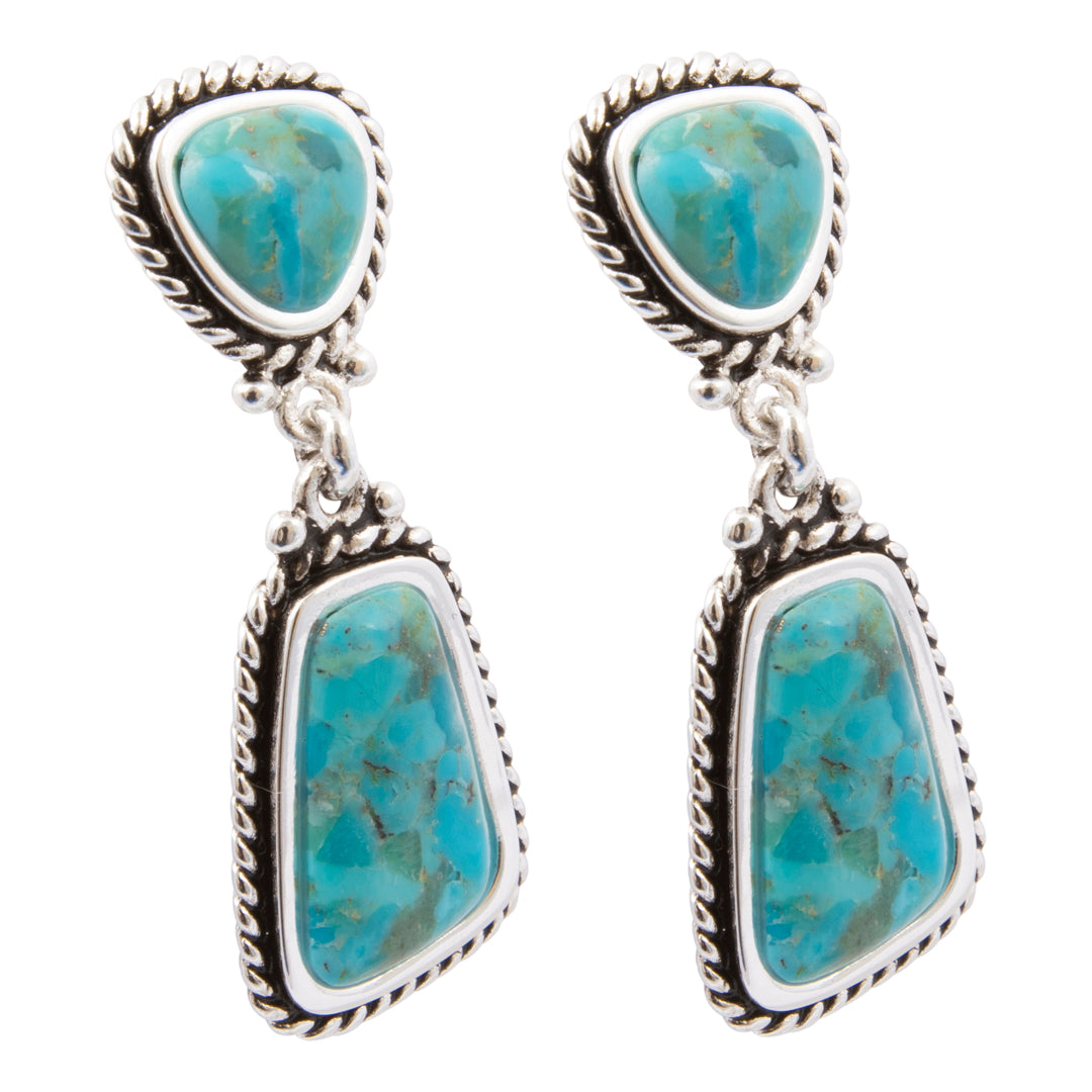 Turquoise stone earrings with silver frames on a white background