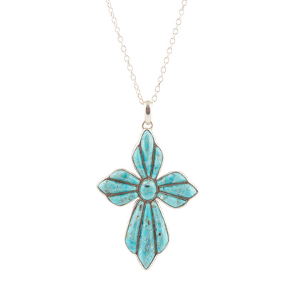Turquoise flower-shaped pendant on a silver chain against a white background