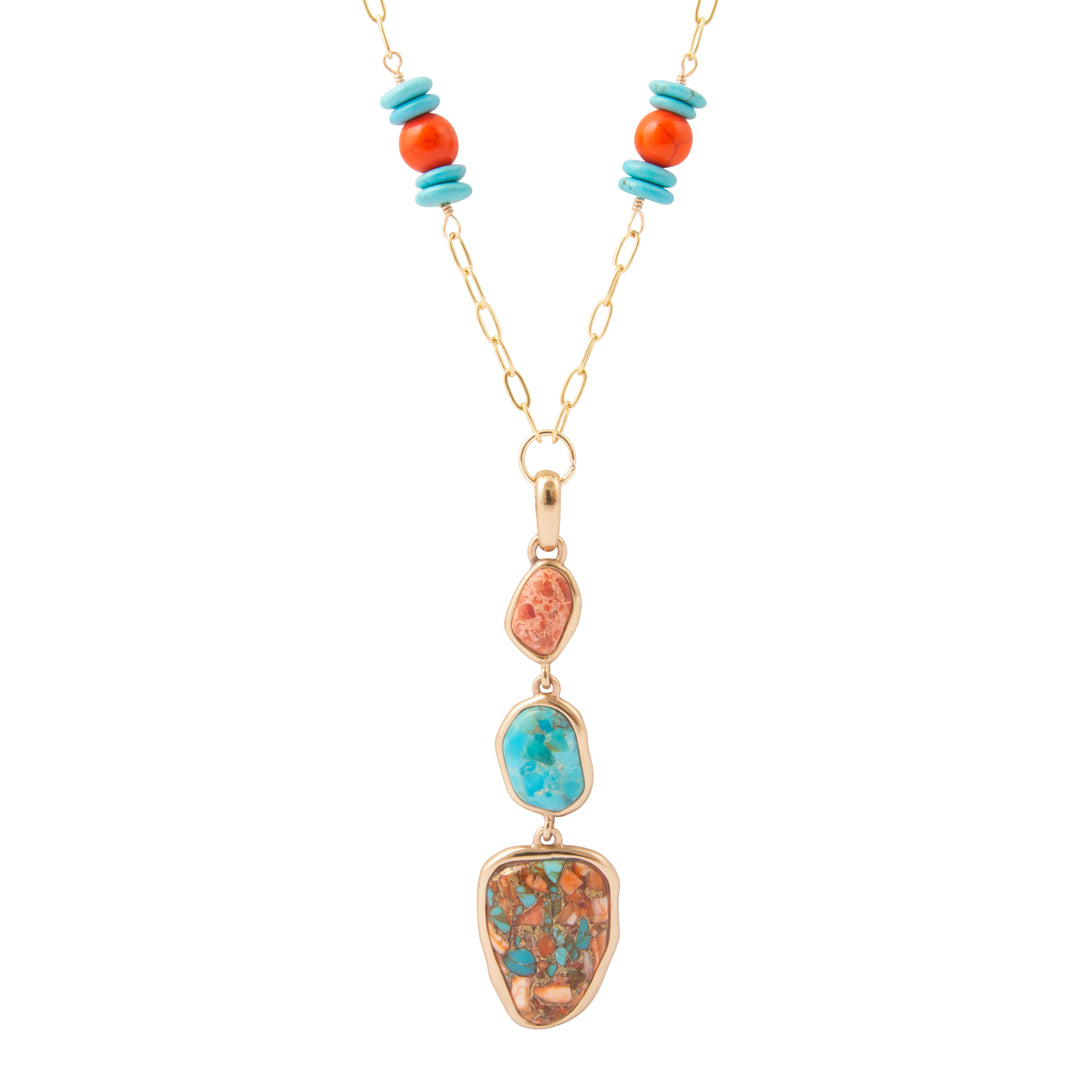A gold chain necklace featuring a vertical drop pendant with three stacked natural stone sections in turquoise, coral, and brown with turquoise flecks, accented by turquoise and coral beads on the chain.