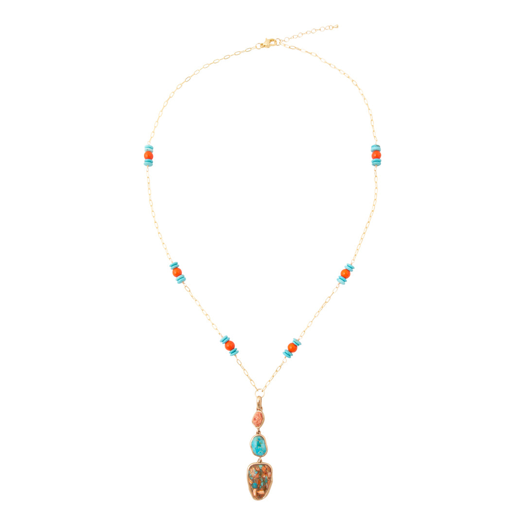 A gold chain necklace with turquoise and orange bead accents and a large oval turquoise pendant, displayed on a clean white background.