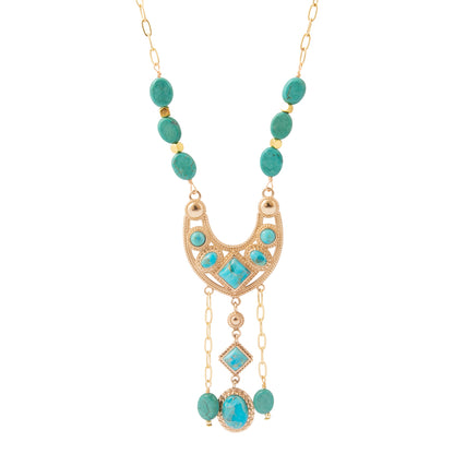 A gold-tone statement necklace featuring turquoise-colored gemstone beads and a crescent-shaped pendant with matching turquoise stones, set against a plain white background.